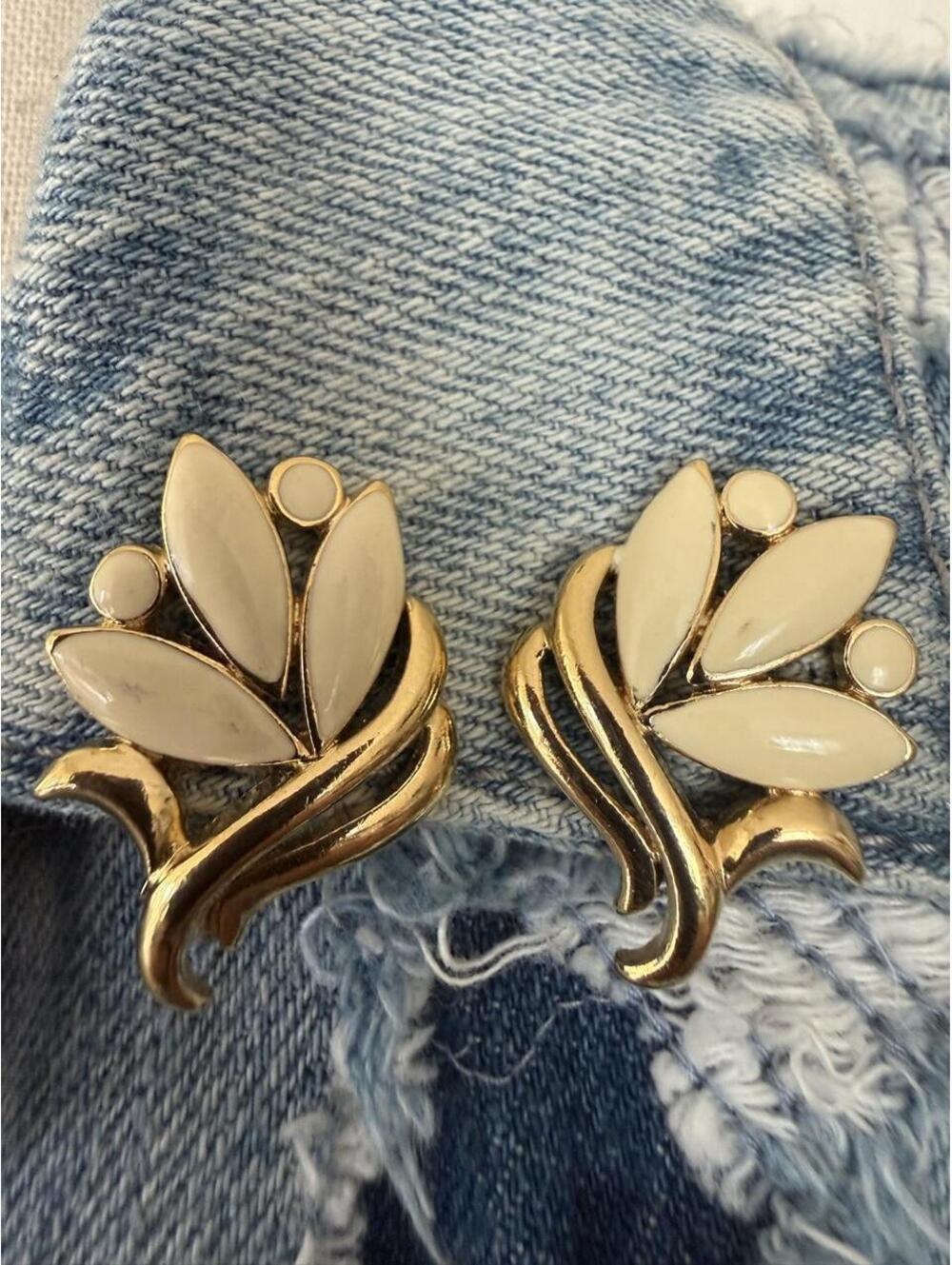 Signed Trifari white enamel floral clip-ons.
